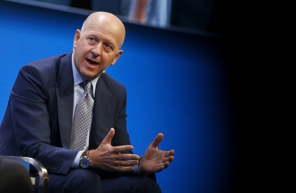 A business executive speaking on stage during a financial conference, related to David Solomon leadership news and corporate strategy updates.