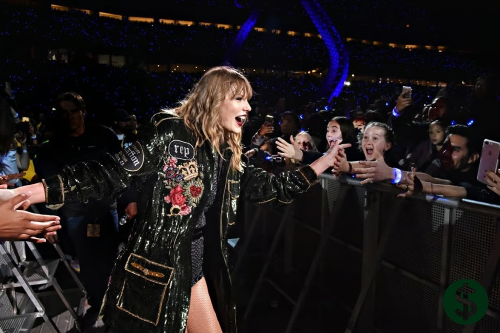 Taylor Swift net worth reflected as the global pop icon greets fans during a packed stadium concert, highlighting her massive tour success and fan-driven empire.