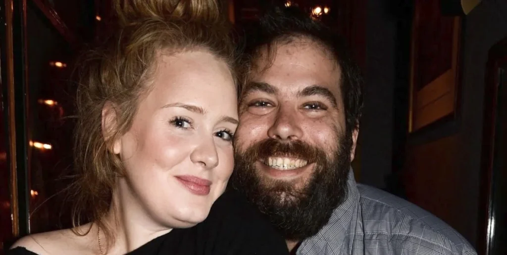 Adele smiling with her partner at a private event, highlighting her personal life alongside her successful music career and Adele Net Worth.